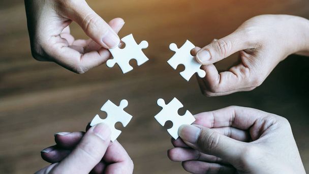 close up hand of group business partnership people puting together a jigsaw puzzle  , business teamwork Strategy concept - Foto, immagini