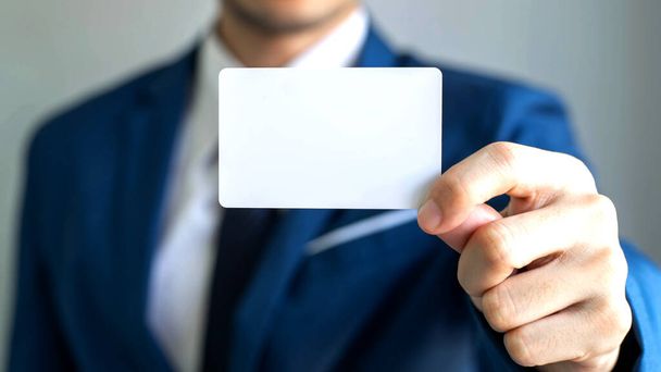 businessman  holding and showing empty business card or name card - business concept - Photo, Image