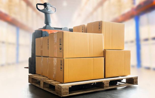 Package Boxes on Pallet with Electric Forklift pallet Jack Load at The Storage Warehouse. Storehouse, Shipping Warehouse Logistics. - Photo, Image