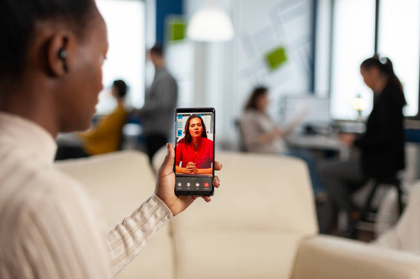 Yli sholder musta työntekijä keskustella kumppanin kanssa videopuhelu - Valokuva, kuva
