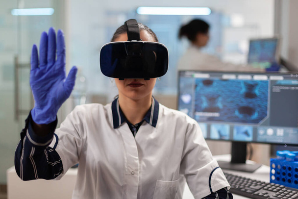 Close up of scientist using vr goggles augmented reality - Photo, Image