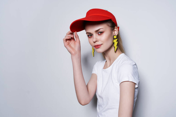 fashion girl in red cap yellow earrings summer fashion studio - Photo, Image