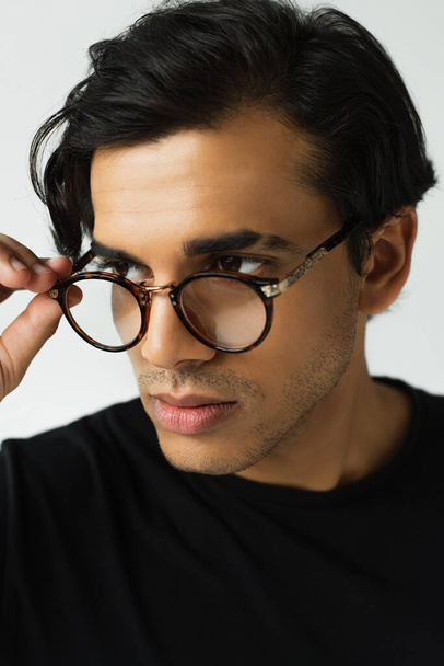 stylish man adjusting eyeglasses isolated on grey - Φωτογραφία, εικόνα