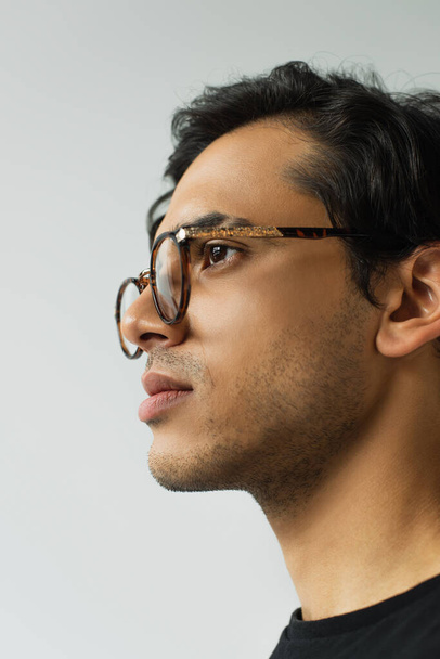 portrait of trendy man in eyeglasses looking away isolated on grey - Photo, image