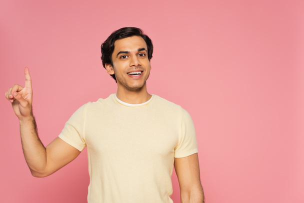 cheerful young man pointing up with finger isolated on pink - Photo, Image