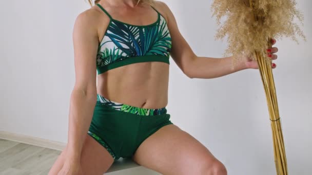 girls pose in a photo studio in swimsuits, advertising them for sale. - Footage, Video
