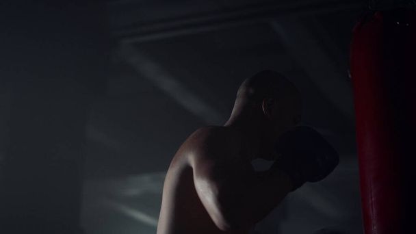 Man boxing punch bag in fitness club. Male fighter kickboxing sports bag - Φωτογραφία, εικόνα
