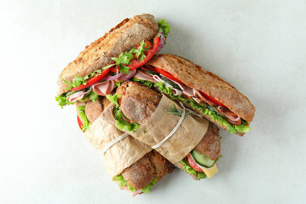Tasty ciabatta sandwiches on white textured background - Photo, Image
