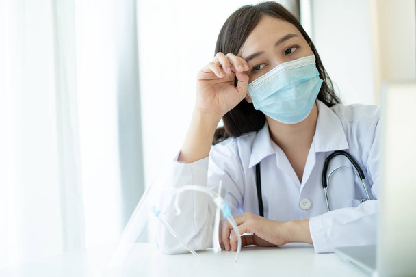 Hard working of Asian young female doctor in hospital, stressful - workaholic health care worker in hospital. Medication working tired from hard working. - 写真・画像