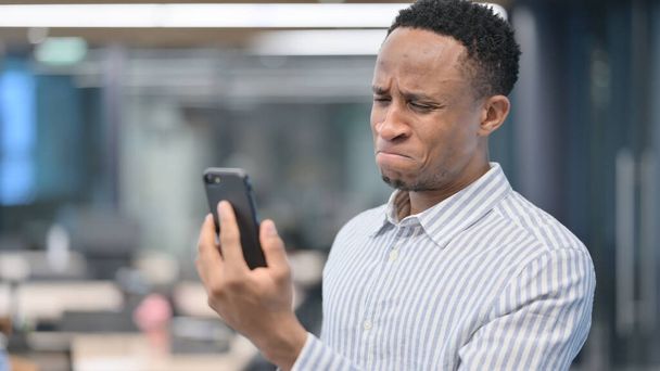 Portrait of African Businessman Loss on Smartphone - Photo, image