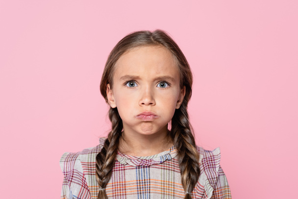 bored girl puffing cheeks while looking at camera isolated on pink - Photo, Image