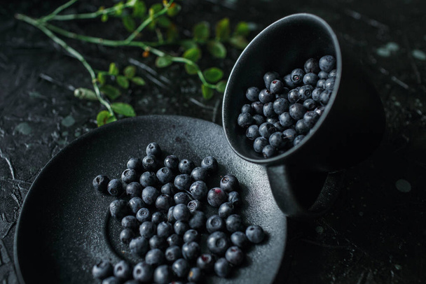 blueberries in a cup, black background - Photo, image