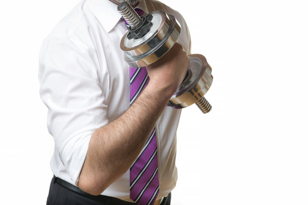 Businessman holding silver dumbbell - Zdjęcie, obraz