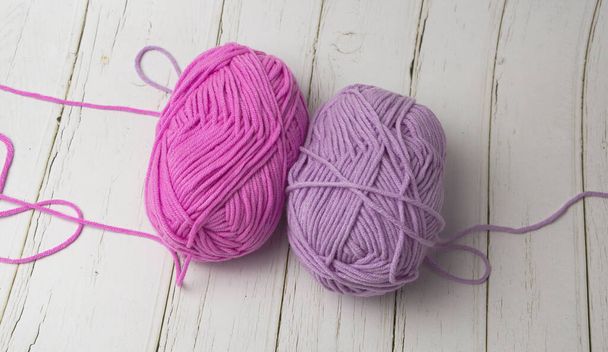 Pink and Purple color of yarns put on wooden timber board - Photo, Image