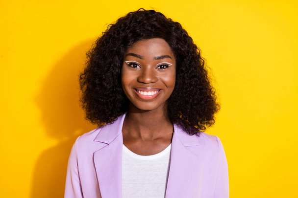 Photo of young beautiful happy cheerful smiling afro businesswoman with curly hair isolated on yellow color background - 写真・画像