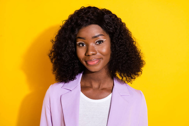 Photo of young beautiful dreamy charming positive smiling afro businesswoman isolated on yellow color background - Photo, image
