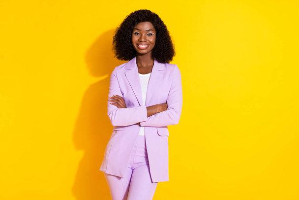 Photo of young happy cheerful lovely african businesswoman with crossed hands isolated on yellow color background - Photo, image