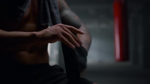 Boxeador usando envolturas de perforación en el gimnasio. Hombre envolviendo manos con cintas de boxeo - Metraje, vídeo