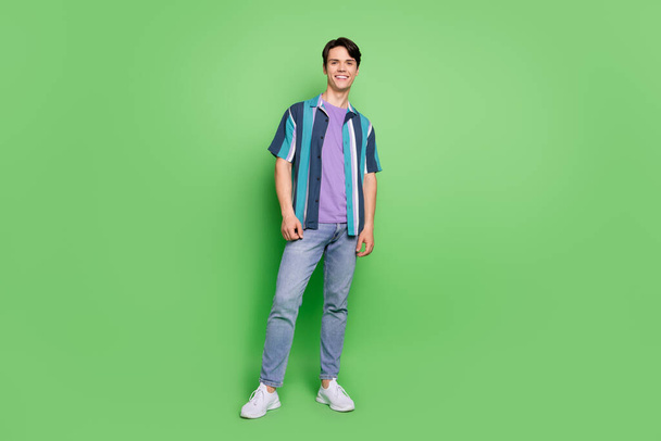 Full body photo of charming happy positive man wear casual clothes smile isolated on green color background - Foto, Imagen