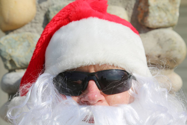 Christmas. Santa Claus. Santa Claus Christmas Portrait. Santa Claus poses for his yearly Christmas Photos. Santa Claus on Vacation. Santa Claus on Holiday. Santa Claus relaxes on his day off. Santa Claus wishes everyone a Happy Christmas. Ho Ho Ho.  - Photo, Image