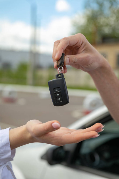 man holding car keys and key - Фото, зображення