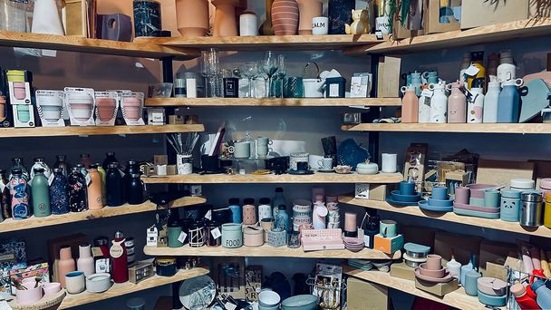 Latvia, Riga, July, 2021 - Shelves with variety handmade earthenware in the shopping mall in Riga, Latvia. Ceramics product concept. - Photo, Image