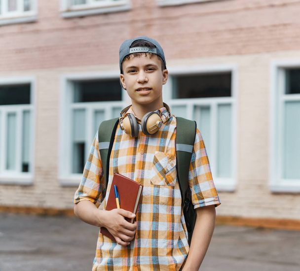 teen boy portrait on the way to school, education and back to school concept - Photo, Image