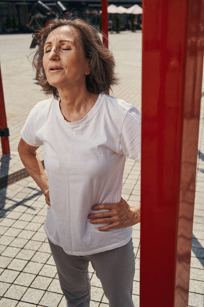 Starší fit žena relaxační po tréninku venku - Fotografie, Obrázek