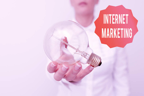 Text showing inspiration Internet Marketing. Business concept drive direct sales of products via electronic commerce Lady in business outfit holding lamp presenting new technology ideas - Photo, Image