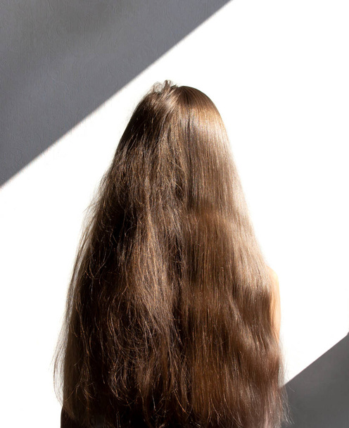 on a white background female head with long hair. before and after using a special shampoo. obedient hair concep - Foto, Bild