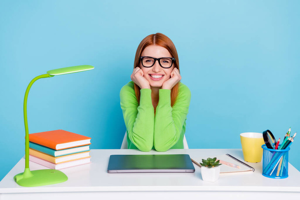 Photo of young clever lady work from home wear spectacles green sweater isolated on blue color background - 写真・画像