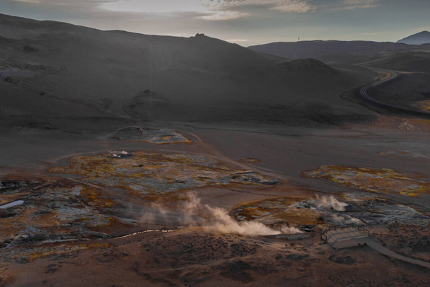 Hverir geothermal mud springs in Iceland close to lake Myvatn. Aerial view of sulphur fumes and bubbling lakes of mud. - Photo, Image