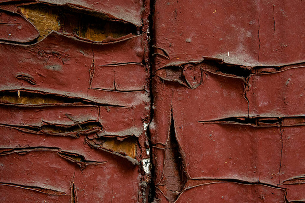 Texture of texture cracks of old paint of a stone, metal, wooden wall with peeling paint, floor of destruction and corrosion of metal and rusty antiquity, chips and paint smears - Photo, Image