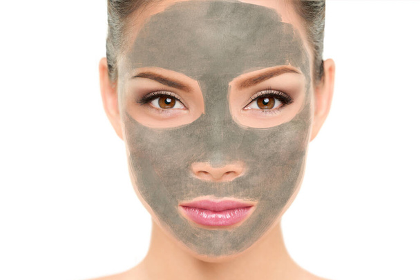 Clay mask facial treatment Asian beauty woman. Wellness and spa purifying peel off mask face portrait, isolated on white background. Cleansing skin care to remove blackheads and clean pores - Zdjęcie, obraz