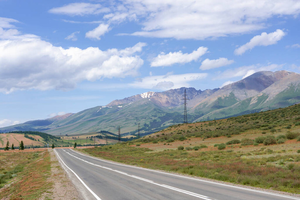 mountains against the background of clouds and the road stretching into the distance - Photo, Image