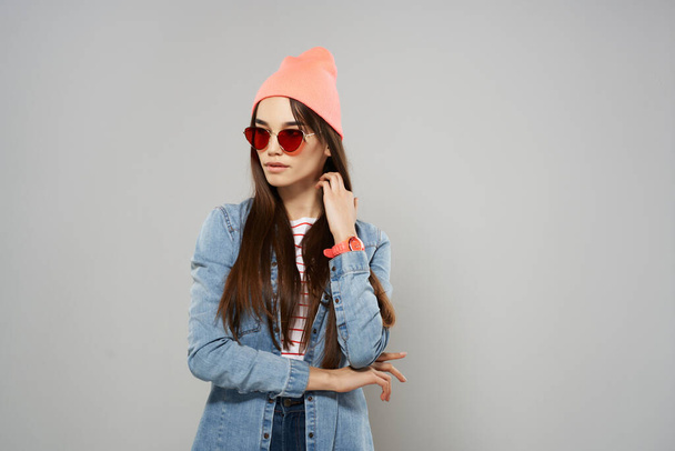 woman in yellow glasses pink hat fashion in modern style gray background - Photo, Image