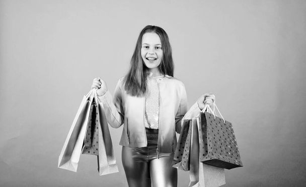Happy child in shop with bags. Shopping day happiness. Buy clothes. Birthday girl shopping. Fashion boutique. Fashion trend. Fashion shop. Little girl with bunch packages. Fashion girl customer - Fotografie, Obrázek