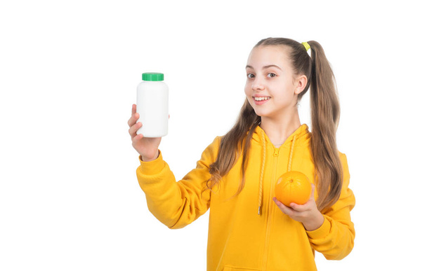 presenting vitamin product. child with orange flavored pill. effervescent tablet for kids. - Photo, image