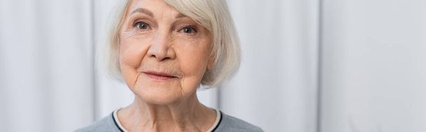 Senior woman looking at camera in clinic, banner  - Photo, image