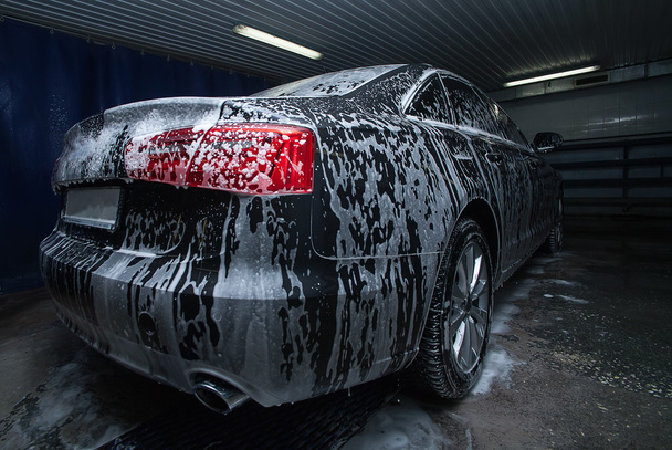 black car in foam on sink - Φωτογραφία, εικόνα