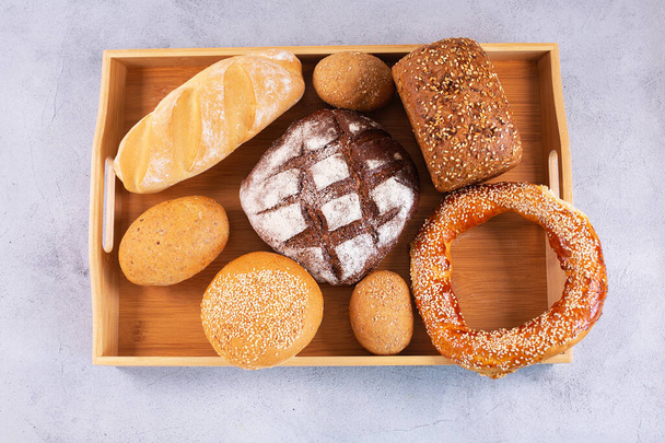 Different kinds of fresh bread on a tray. - Photo, Image