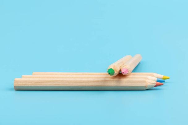 Colour pencils on blue background. Back to school. Education concept - Фото, изображение