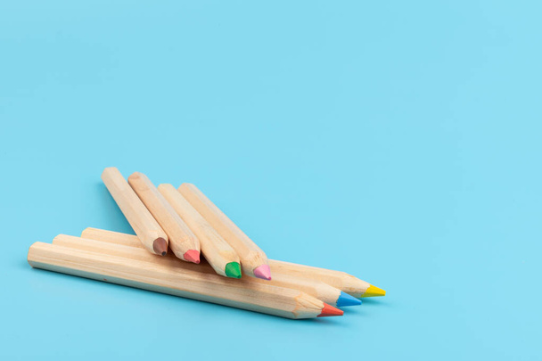 Colour pencils on blue background. Back to school. Education concept - Fotó, kép