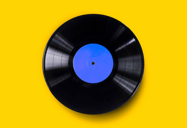 Vinyl record on a colored background. Old vintage vinyl record isolated - Photo, Image