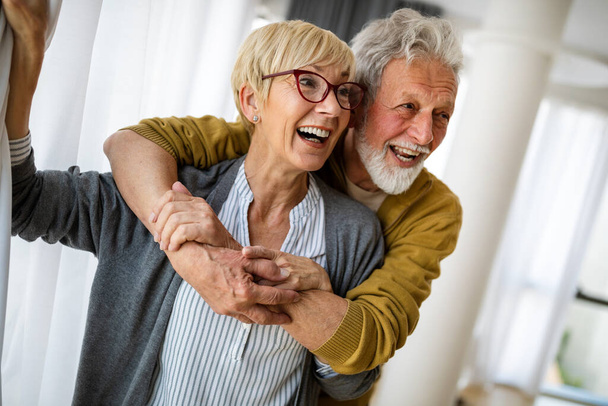 Happy senior couple in love hugging and bonding with true emotions at home - Valokuva, kuva