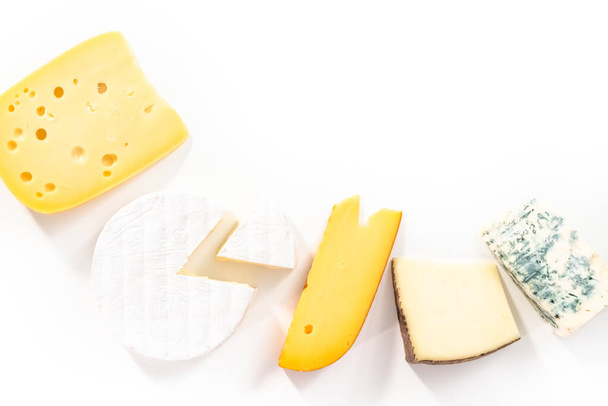 Variety of large wedges gourmet cheese on a white background. - Photo, Image