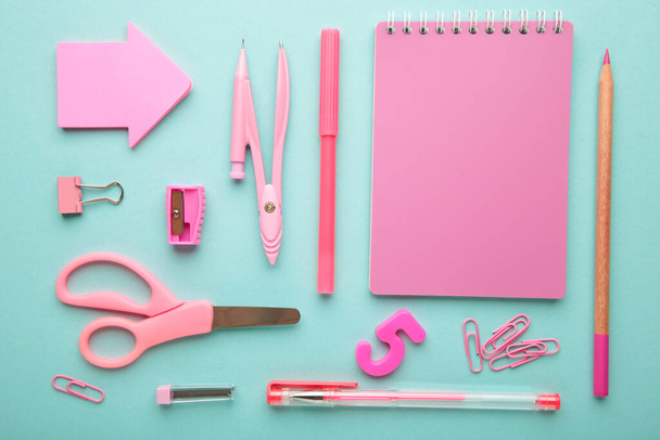Pink school supplies on blue background. Back to school concept. Top view. - Фото, изображение
