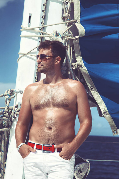 Man enjoying summer time holiday on sailing boat. - Valokuva, kuva