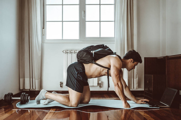 Fit young man doing home workout - Photo, Image