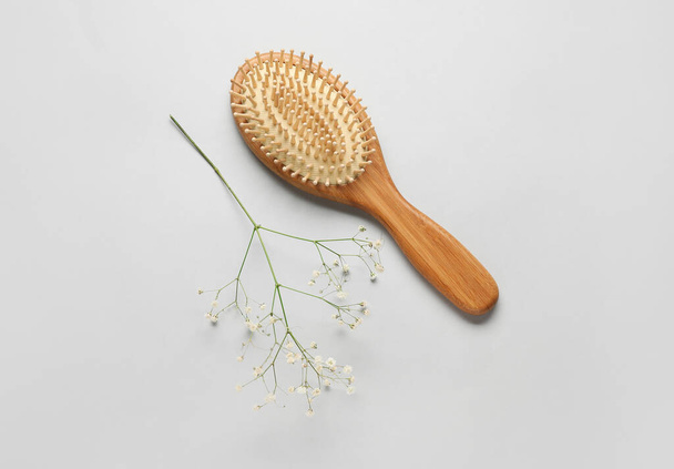 Wooden hair brush on grey background - Fotó, kép